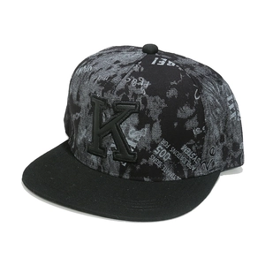 Detailed close-up of 3D embroidered K letter on a graffiti print flat brim hip-hop cap
