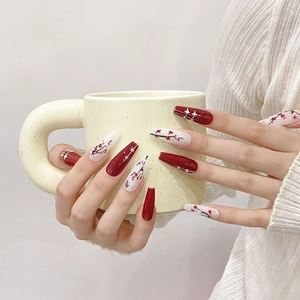 Hand-painted plum blossom press-on nails in red and white coffin shape with pearls