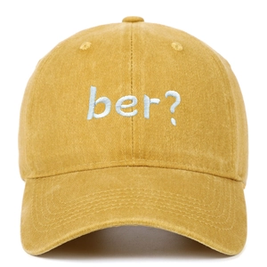 Close-up of light blue 3D embroidered ber question mark on yellow cotton baseball cap