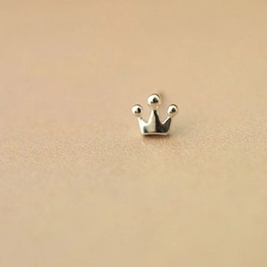 Polished silver geometric crown stud earring for women on minimalist beige background