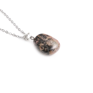 Detail of natural pink and black stone pendant with high-gloss silver metal chain
