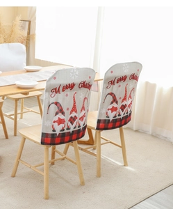 Detail of Christmas gnome chair covers with red buffalo check and Merry Christmas print