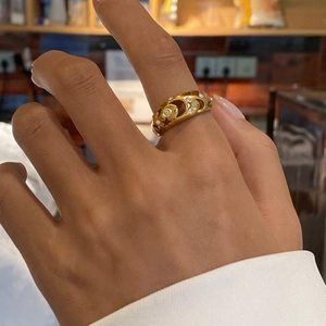 Detailed view of gold-plated star and moon hollow ring with embedded zircon accents