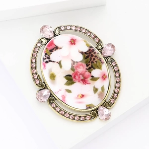 Vintage Baroque floral brooch with pink crystals and antique bronze finish on white base
