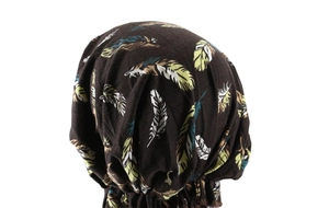 Detail view of the brown turban hat featuring a colorful feather print and pleated design