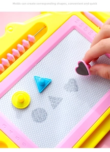 Macro view of magnetic drawing board with heart stamp and honeycomb surface for kids