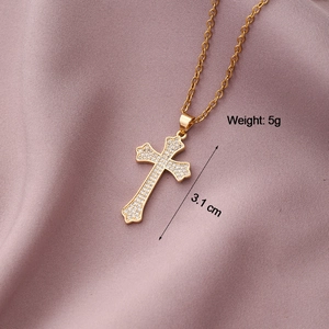 Detailed view of a 3.1 cm gold-plated cross pendant with shimmering white zircon stones