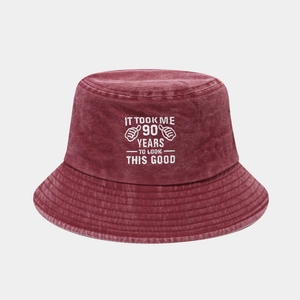 Macro detail of the 90th birthday embroidery on a washed cotton burgundy bucket hat