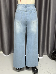 Back view of high waisted light blue denim wide leg jeans with patch pockets and raw hem