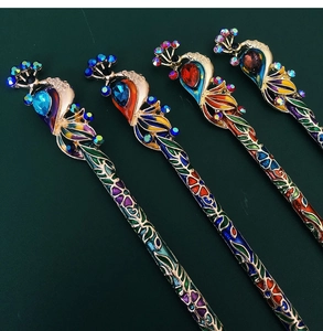 Detailed view of four peacock hairpins with crystal rhinestones and colorful enamel work