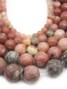 Detailed view of round natural plum blossom jade beads for DIY jewelry making