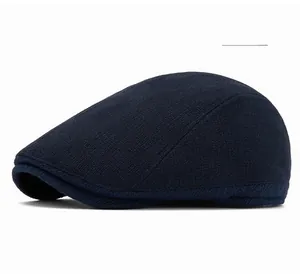 Detailed close-up of navy knit ivy cap featuring textured twill pattern and curved brim