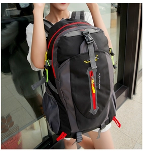 Detail of outdoor hiking backpack featuring waterproof nylon, red zippers and side mesh pocket