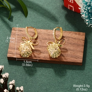 Detail showing bow and gift box earrings with dimensions 2.8cm by 1.5cm and weight