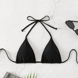 Classic black halter bikini top with adjustable drawstring details on a textured surface