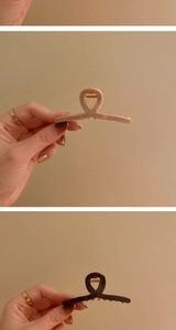 Detail of pink and dark brown minimalist hair claws with durable golden springs