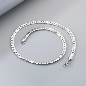 Detailed close-up of a silver flat Cuban link chain featuring a polished lobster clasp