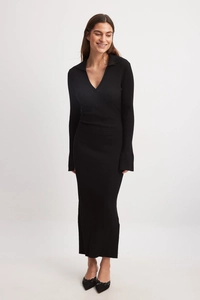 Detail of elegant black ribbed knit long sleeve dress with deep V-neck and collar design