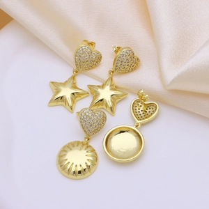 Minimalist gold heart and star earrings with cubic zirconia set on elegant champagne silk
