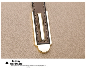 Macro detail of beige lychee grain leather with shiny gold metal accent and stitching