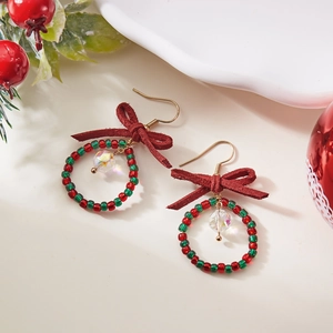 Christmas wreath earrings with red and green beads, a bow, and clear crystal pendant