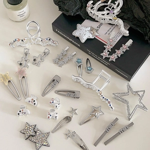 Y2K silver star hair clips with rhinestones and bows in a stylish flatlay setup