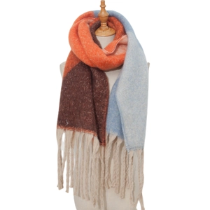 Detailed texture of thick color-block scarf with heavy tassels in orange and brown