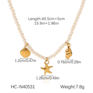 Detail view of pearl necklace features golden shell and starfish charms with dimensions