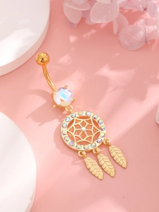 Macro shot of golden dreamcatcher belly ring with iridescent gems and feather pendants