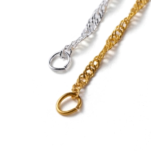 Macro view of gold and silver DIY jewelry link chains with lobster clasps and jump rings