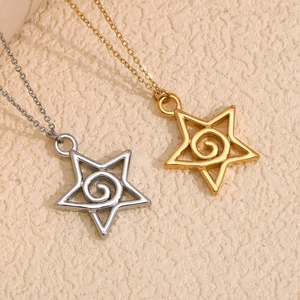 Detail of gold and silver necklaces featuring hollow star pendants with spiral motifs