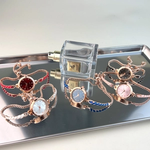 Detailed display of slim rose gold women's quartz watches with colorful enamel bracelets