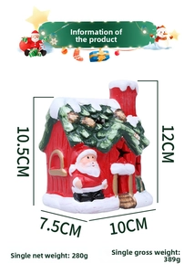 Detail view of a ceramic Christmas LED house decoration with Santa Claus and snow details