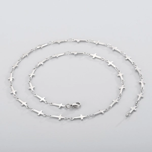 Detail view of silver stainless steel cross chain necklace with lobster clasp closure