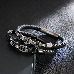 Detail of men's leather woven bracelet and retro stainless steel anchor link chains