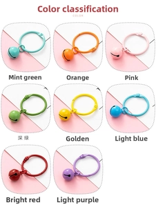 Detailed view of colorful metal ring keychains and matching bells in various pastel colors
