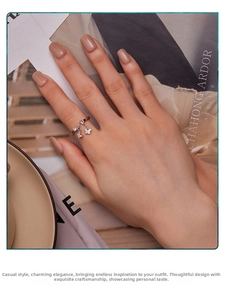 Detail of s925 silver butterfly tassel ring with sparkling pavé stones on hand