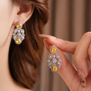Luxurious silver earrings with yellow teardrop zircon and intricate floral marquise gems