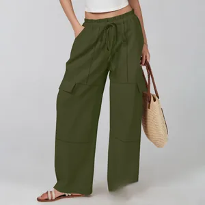 Close-up of olive green cargo pants with adjustable drawstring waist and side flap pockets