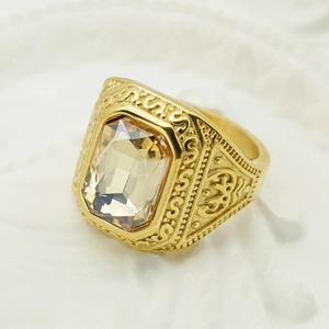 Macro detail of vintage gold ring featuring champagne rectangle gemstone and floral carving