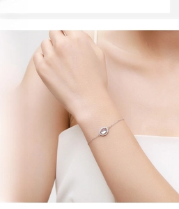 Detailed view of elegant S925 silver bracelet featuring a glowing moonstone on a model wrist