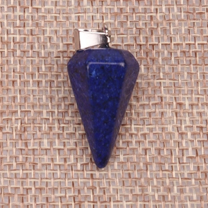 Lapis blue natural stone hexagonal cone pendant with silver metal clasp on rustic fabric