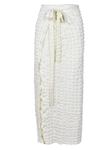 Detail of high waisted cream wrap skirt featuring textured seersucker fabric and side tie