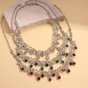 Vintage palace style silver necklace set with red and green crystals and floral vine design