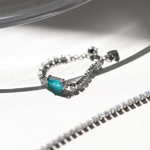 Silver adjustable ring with rectangular Paraiba blue zircon and sparkling crystals