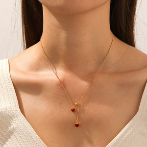 Gold stainless steel necklace with double red heart pendants shown on a model neck