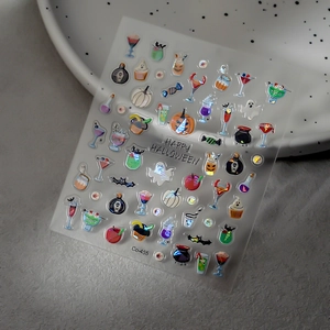 Laser Halloween nail stickers featuring ghosts, pumpkins and potions on a ceramic plate