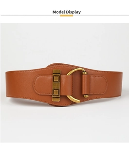 Close-up of brown leather wide belt with vintage gold metal buckle and D-ring detail