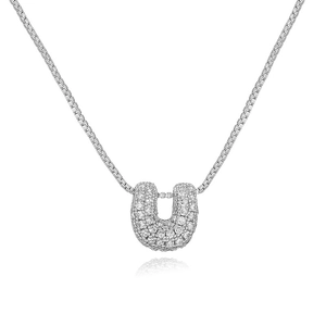 Detail of silver U-shaped pendant with cubic zirconia on a delicate box chain