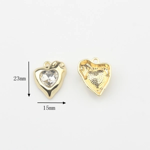 Detail view of gold alloy heart pendant with crystal inlay showing 23x15mm dimensions